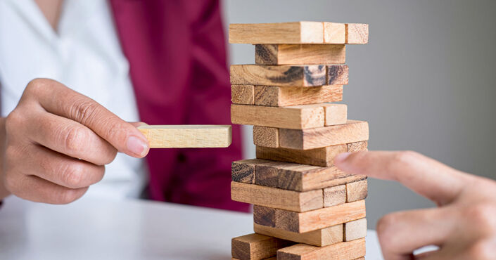 A picture shows Jenga game which represents for merchants challenges and solutions to accepting payments online.