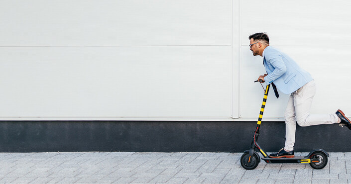 Illustration of mobility industry rise where a business casual man is riding a scooter 